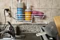 Dish soap in shower caddy above kitchen sink.