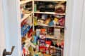 Before: a door opening of a white pantry filled with food