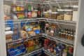 Before: pantry with four wire shelves stuffed with food