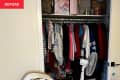 closet before organizing: too much to fit, things in shopping bags on top shelf