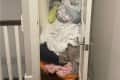 Linen closet before organizing: linens, sheets, pillows, towels, etc all shoved into a closet