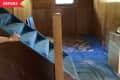 Before: Stairs leading to dated '70s basement with blue carpet