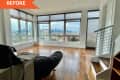 Spacious living room with large windows showcasing a city skyline, hardwood floors, and a black bean bag chair.