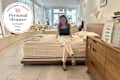 Someone sitting on a bed in the Avocado store