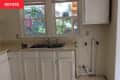 Kitchen countertop and cabinets before renovation.