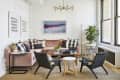 Living room with a pink sectional and black accent chairs
