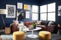 Navy blue living room with brown sectional sofa, yellow ottomans, white round table, and framed art on walls.