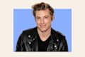 Jeremiah Brent headshot on wisteria background.