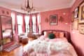 Pink painted bedroom.