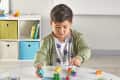 boy playing with buildable colorful tiles