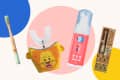 Children's dental care products including a bamboo toothbrush, lion-themed mouthpiece, foaming toothpaste, and electric toothbrush.