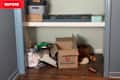 Boxes and clutter in closet nook before renovation.