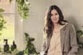 Courteney Cox in a kitchen with leaves and cleaning products