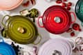 Le Creuset cookware on table overhead shot