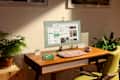 A modern workspace featuring a wooden desk, green chair, computer monitor displaying apps, a glass of water, and a potted plant.