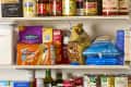 head on shot of an assortment of pantry items on white wire pantry shelves.