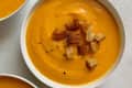 Three bowls of root vegetable potage (thick, creamy, blended soup) with croutons on top