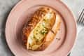 baked potato on a plate with butter and chives