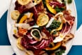 Fall Panzanella with Crispy leeks on white platter. Ble and white graphic background