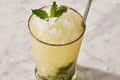 mint julep in a glass with mint on the bottom and top