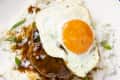overhead shot of loco moco on a white plate, served over rice.