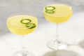 Photo of two bee sting cocktails with sliced jalapeno pepper garnish.