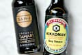 close up shot of a bottle of organic tamari on the left, and a bottle of soy sauce on the right.