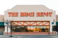 The Home Depot storefront with orange signage and a "Now Hiring" sign in the window.