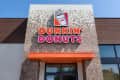Dunkin' Donuts storefront with mosaic tiles and orange awning.