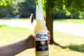 someone holding a Corona Colada at the park