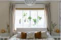 A bedroom with a semi flush-mount decorative light