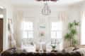 White living room with throws draped over rungs of leaning ladder