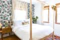 sheer window treatments against a bold wallpaper in a bedroom