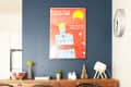 Dining room with wooden table, black chairs, fruit bowl, and a red poster on a navy accent wall.