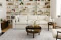 White living room with Cozey Ciello sofa and built in bookshelves