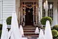 Pottery Barn's Lit Ghost Collection in front of a home