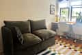 Cozey Green Gaia sofa in colorful living room.