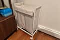 ENHET Laundry bin with casters in someone's home