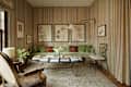 Striped wallpaper in living room with green velvet sofa.