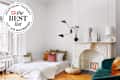 white stylish room with mattress with white linens and throw pillows on floor with seal in upper left that reads "Apartment Therapy the Best List 2023 Air Mattresses"