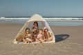 5 kids in a popup Lozi & Gabe tent on the beach