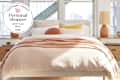 West Elm bed with personal shopper seal in upper left