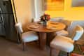 Dayalane dining chairs and table topped with woven placemats.