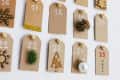 DIY advent calendar made of tags with small holiday decorations