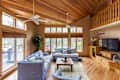 Hardwood floor and wood paneled ceilings in living room
