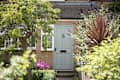 A general exterior view of a sage green front door of a house