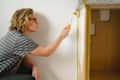 Woman painting cupboard