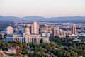 Salt Lake City skyline with Utah State Capitol in the foreground and Wasatch mountain range in the background in the clear summer evening sunset sky