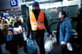 A volunteer supports people fleeing war-torn Ukraine arrive on a train from Poland at the Hauptbahnhof main railway station on March 6, 2022 in Berlin, Germany.