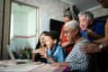 Family and friends doing a video conference on laptop at home